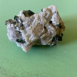 Green tourmaline crystal on feldspar